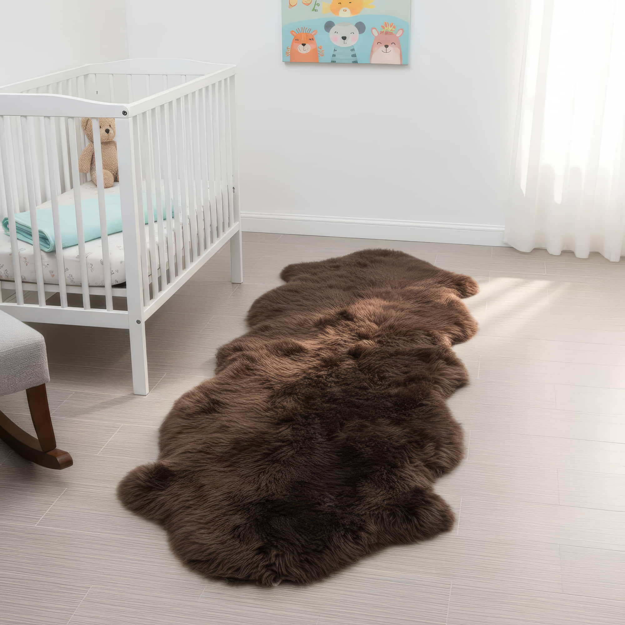 Brown fur rug on a light wooden floor in a nursery with a crib and teddy bear. #size_2' x 6'
