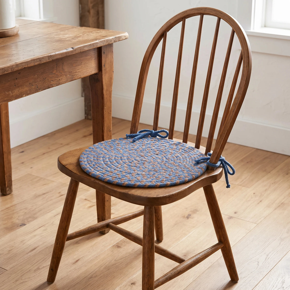 Hartford Braided Chair Pad - Blue Lake - tied on a wooden Windsor dining chair