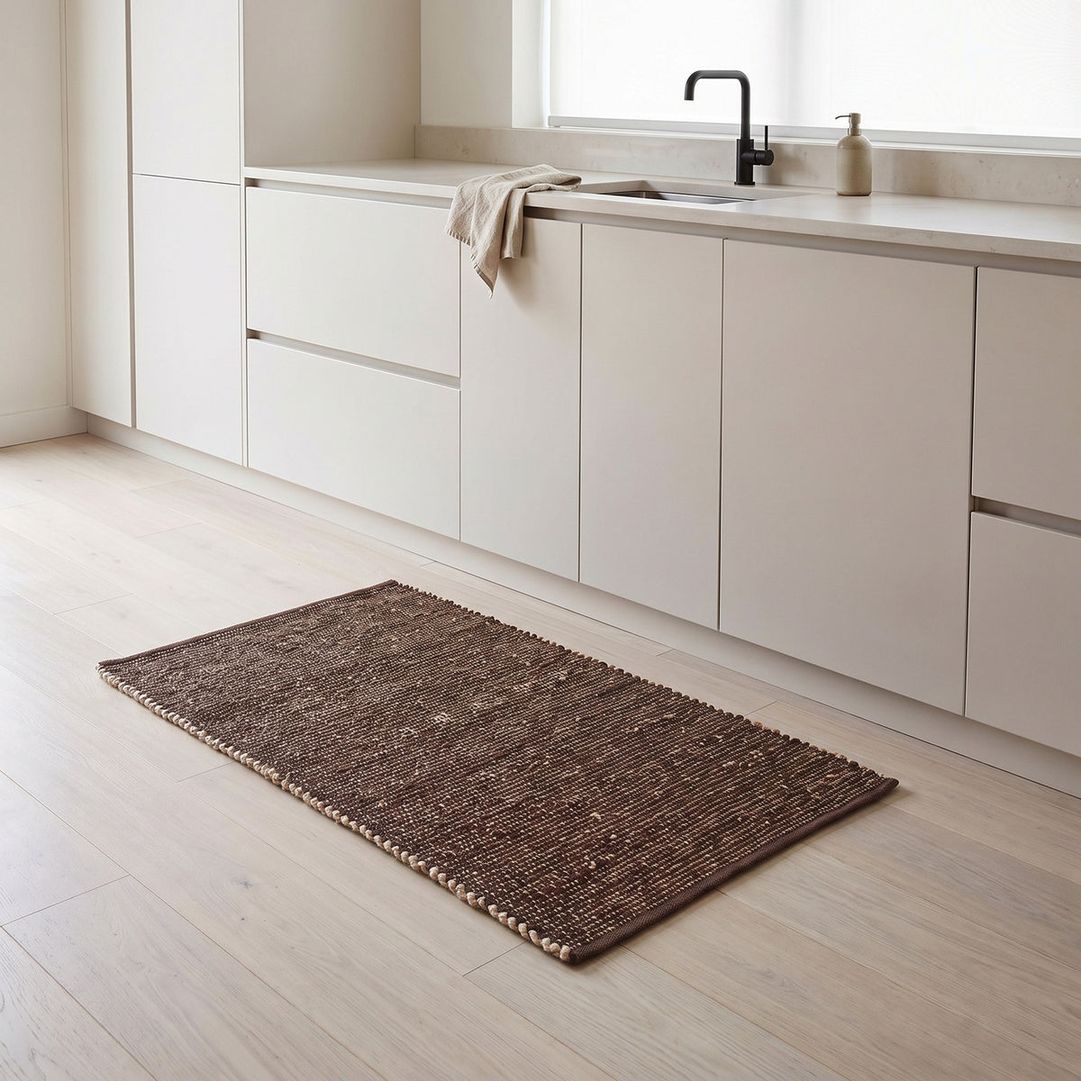 Terra brown jute and cotton runner rug, 2' x 4', in a kitchen