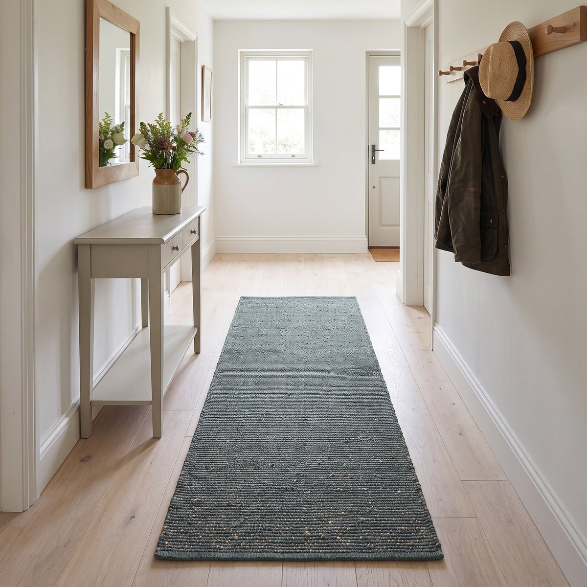 Terra green jute and cotton runner rug, 2' x 6', in a hallway
