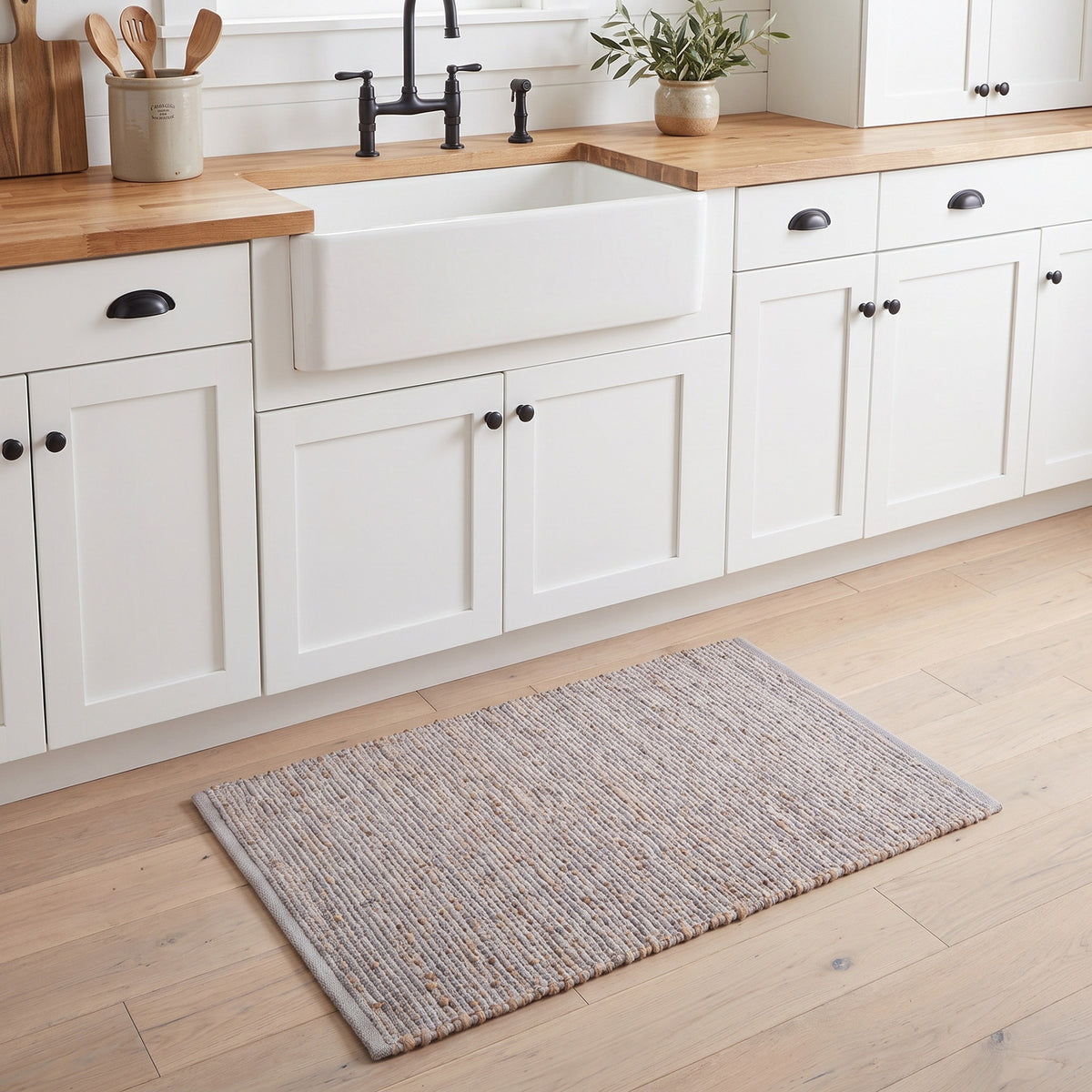 Terra light gray jute and cotton rug, 20" x 30", at a kitchen sink