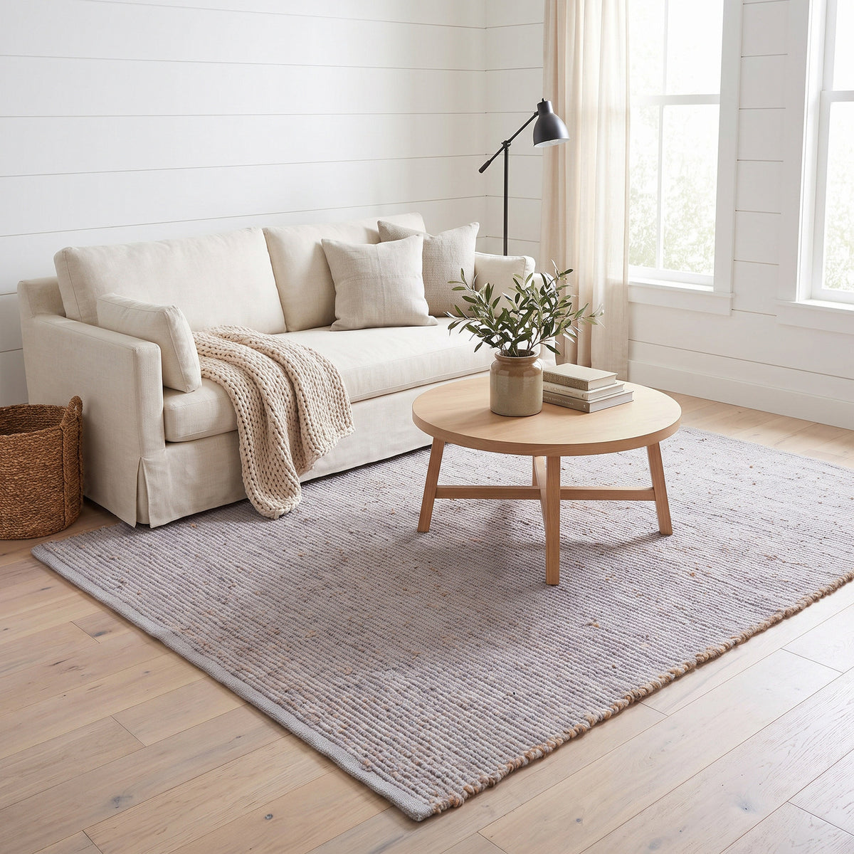 Terra light gray jute and cotton rug, 5' x 7', in a living room