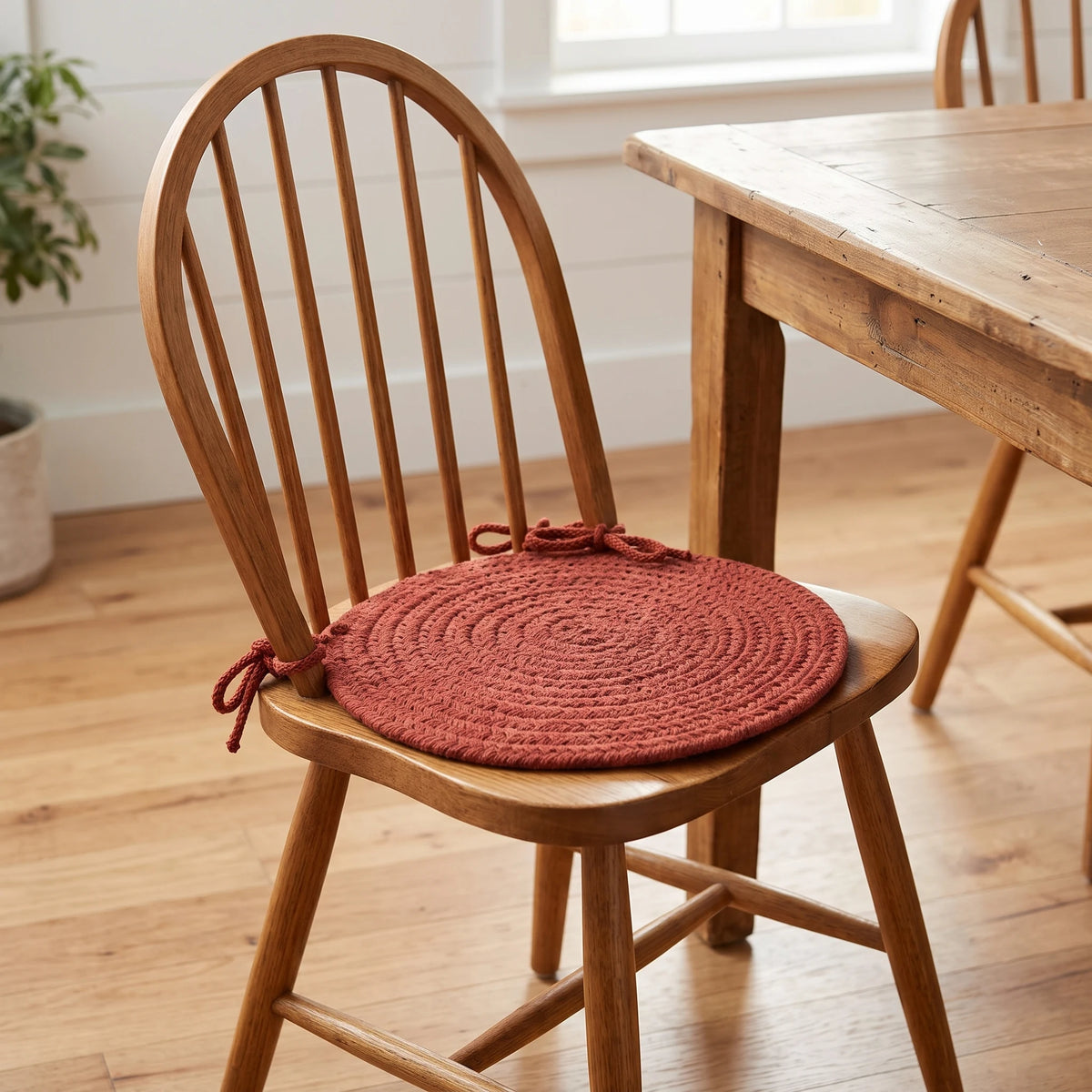 Maui Braided Chair Pad - Terra Cotta - tied on a wooden Windsor dining chair