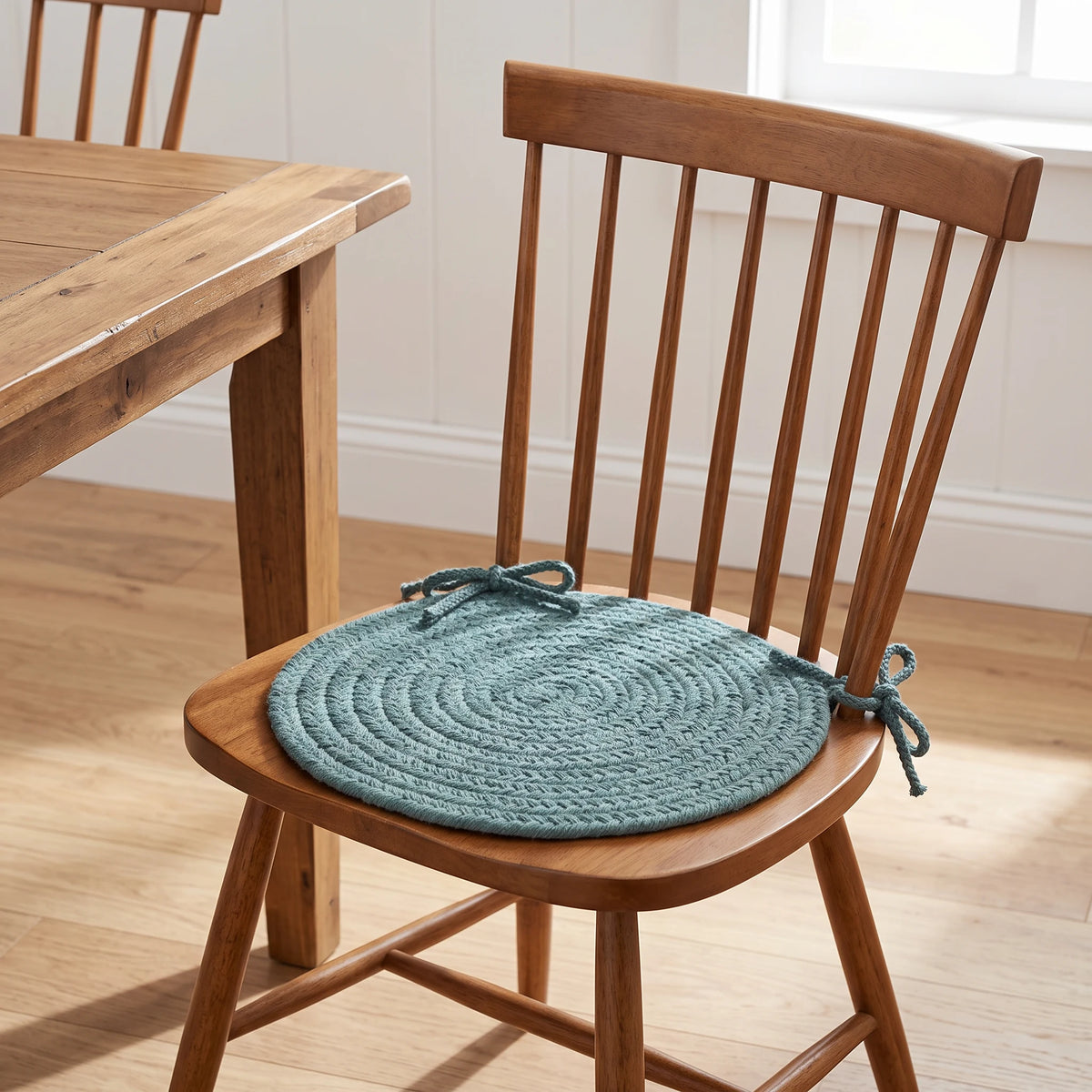 Maui Braided Chair Pad - Teal Green - tied on a wooden Windsor dining chair