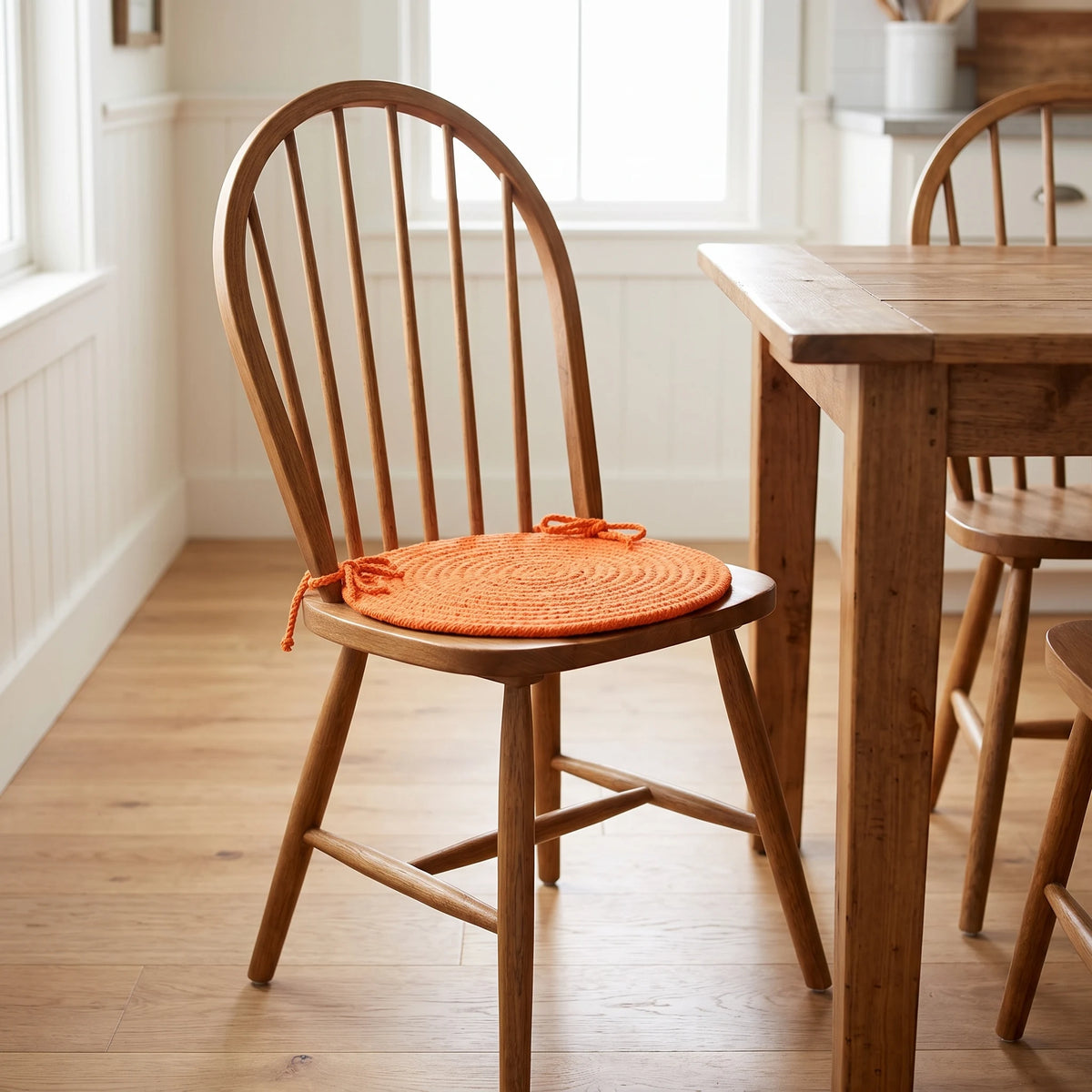Maui Braided Chair Pad - Mango Orange - tied on a wooden Windsor dining chair