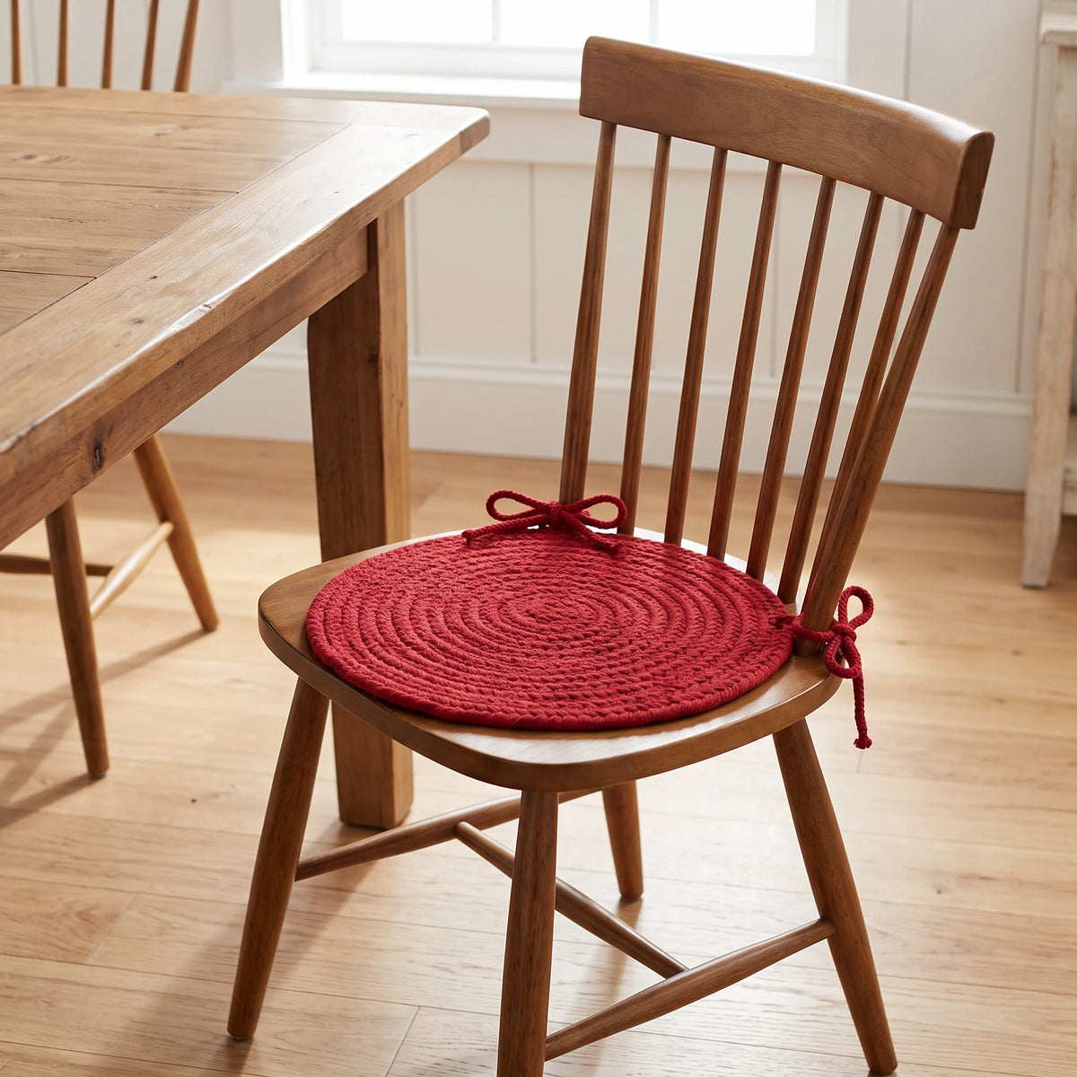 Pura Braided Chair Pad - Scarlet Red - tied on a wooden Windsor dining chair
