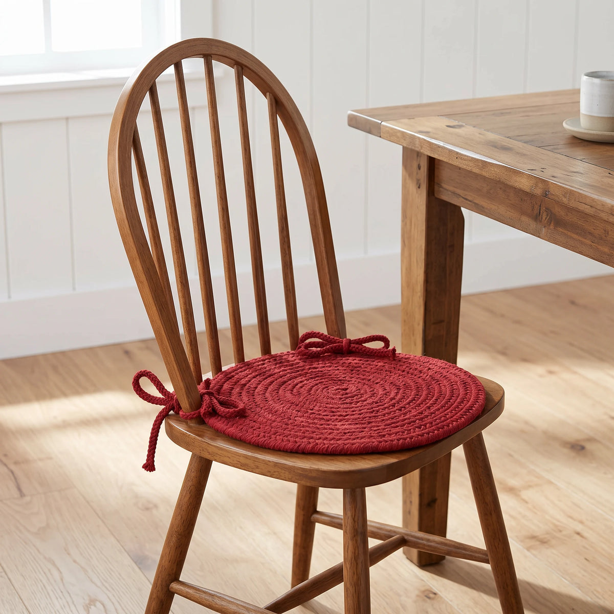 Pura Braided Chair Pad - Barn Red - tied on a wooden Windsor dining chair