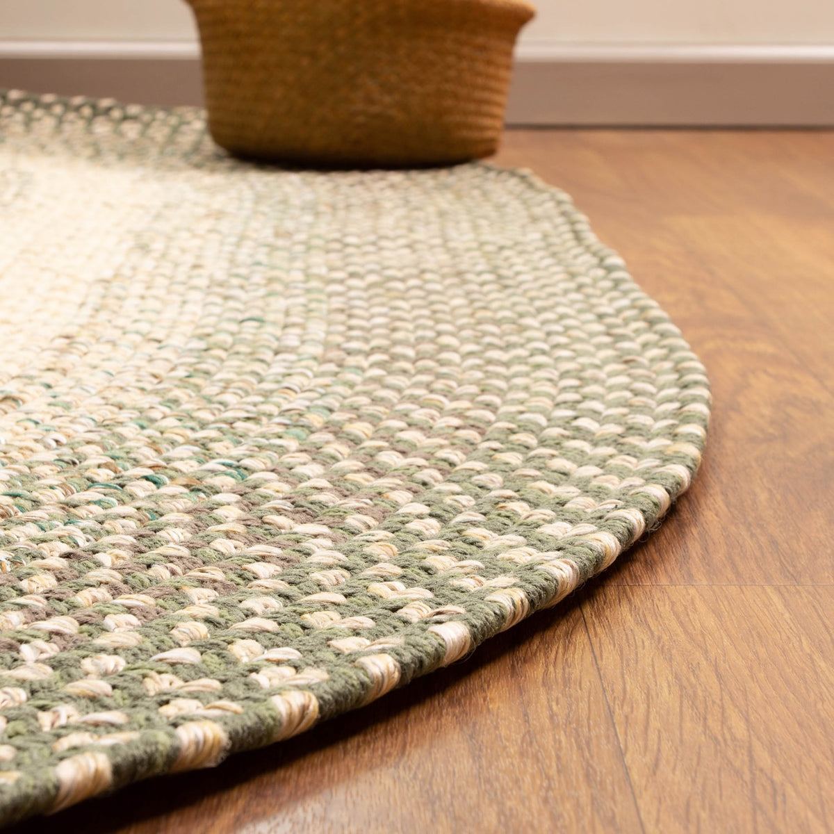Ridgewood Forest Green braided rug - braided border detail on a wood floor