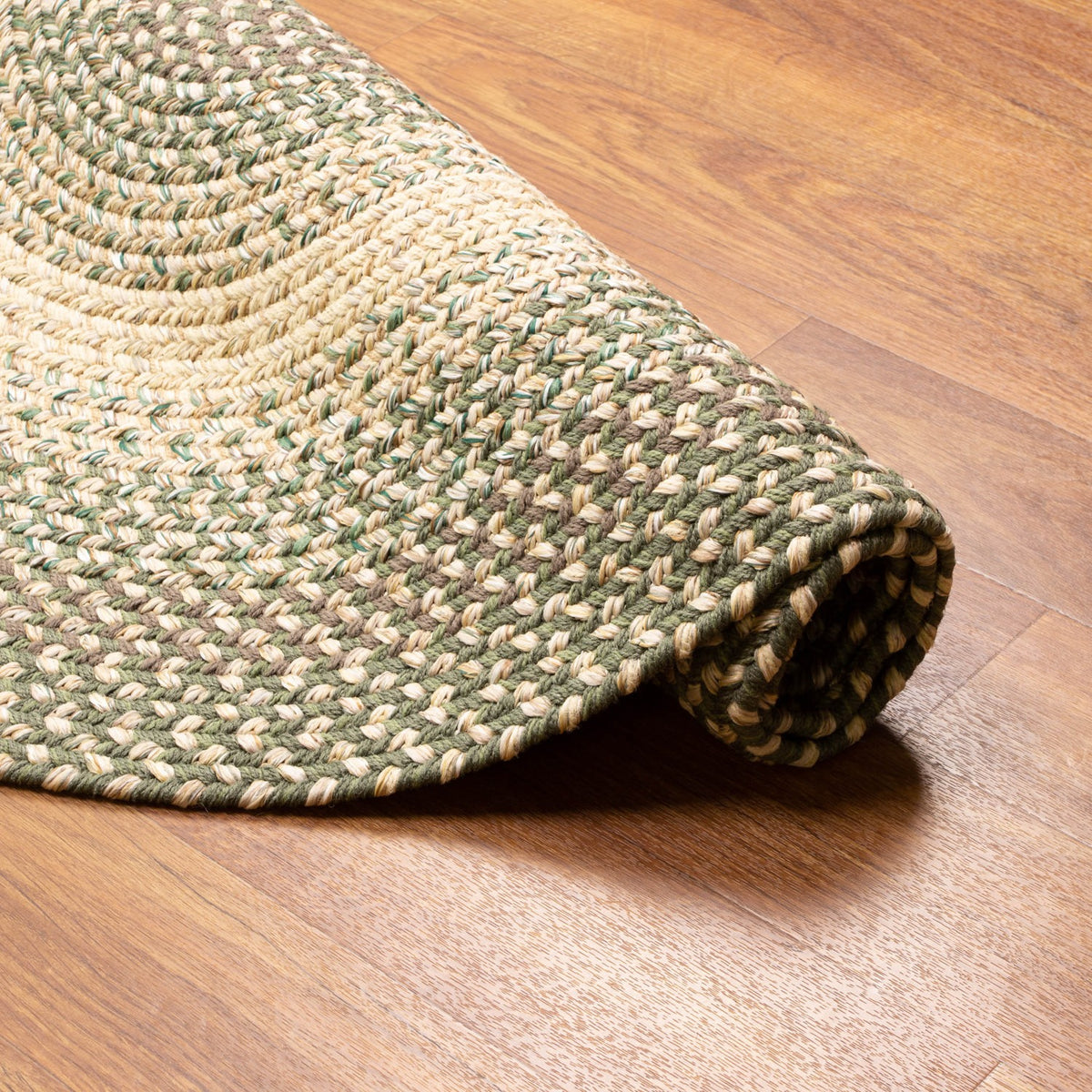 Ridgewood Forest Green braided rug - rolled corner showing flexible construction