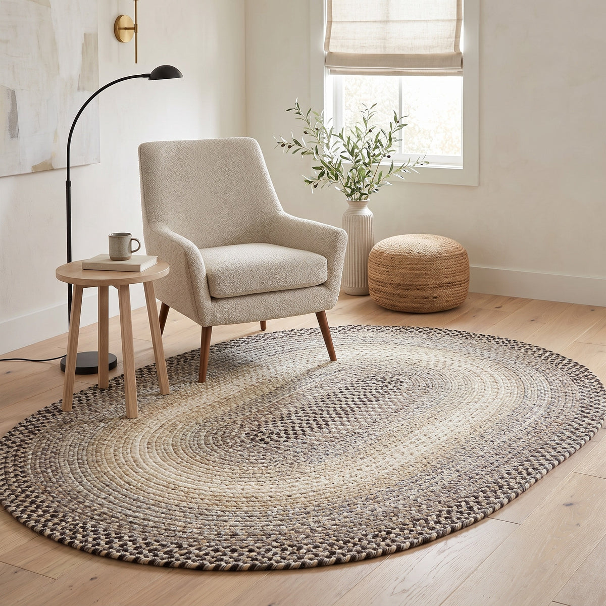 Ridgewood gray braided wool rug, 4x6 oval in a reading corner with a boucle chair #Size_4' x 6' Oval