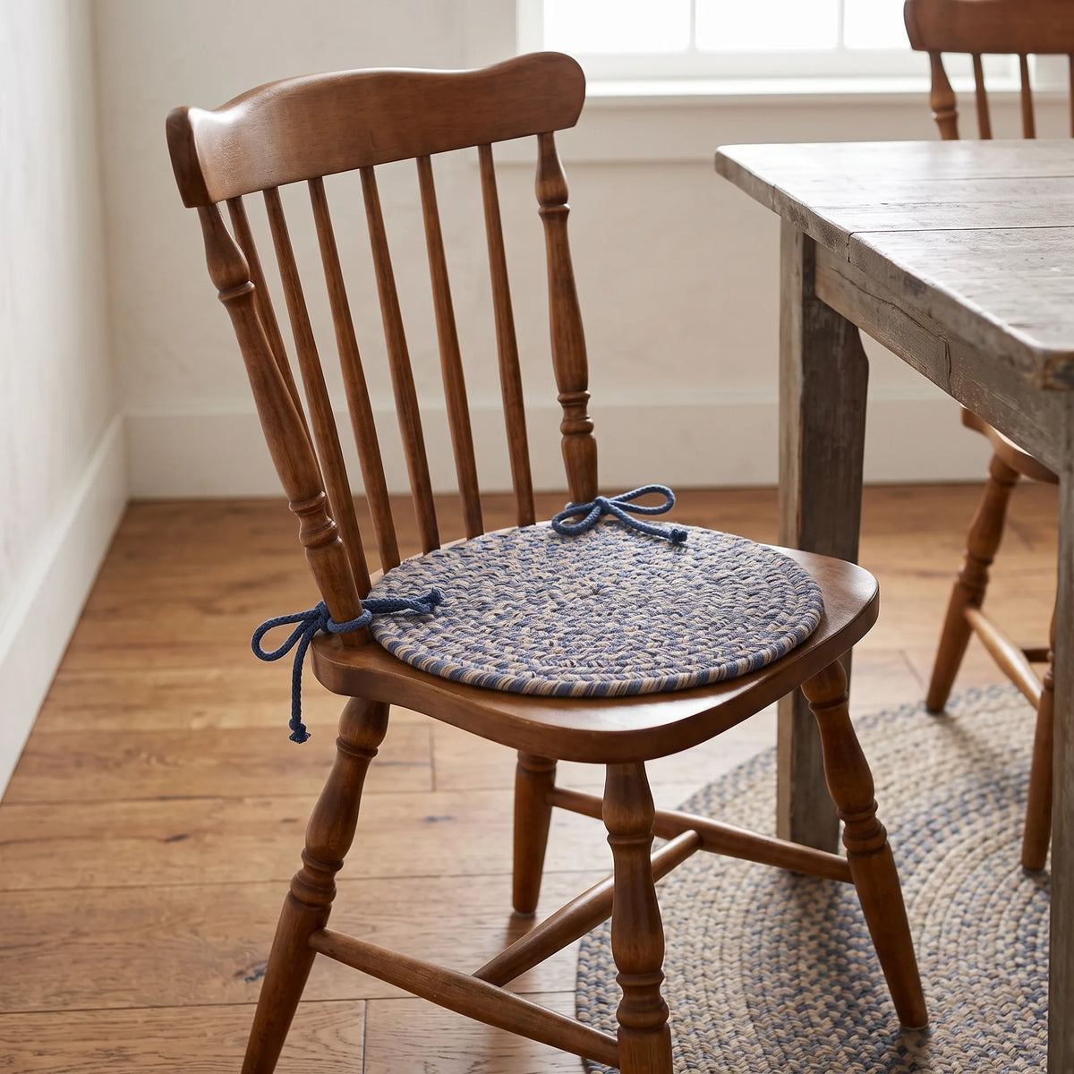 Ridgewood Braided Chair Pad - Blue - tied on a classic wooden dining chair