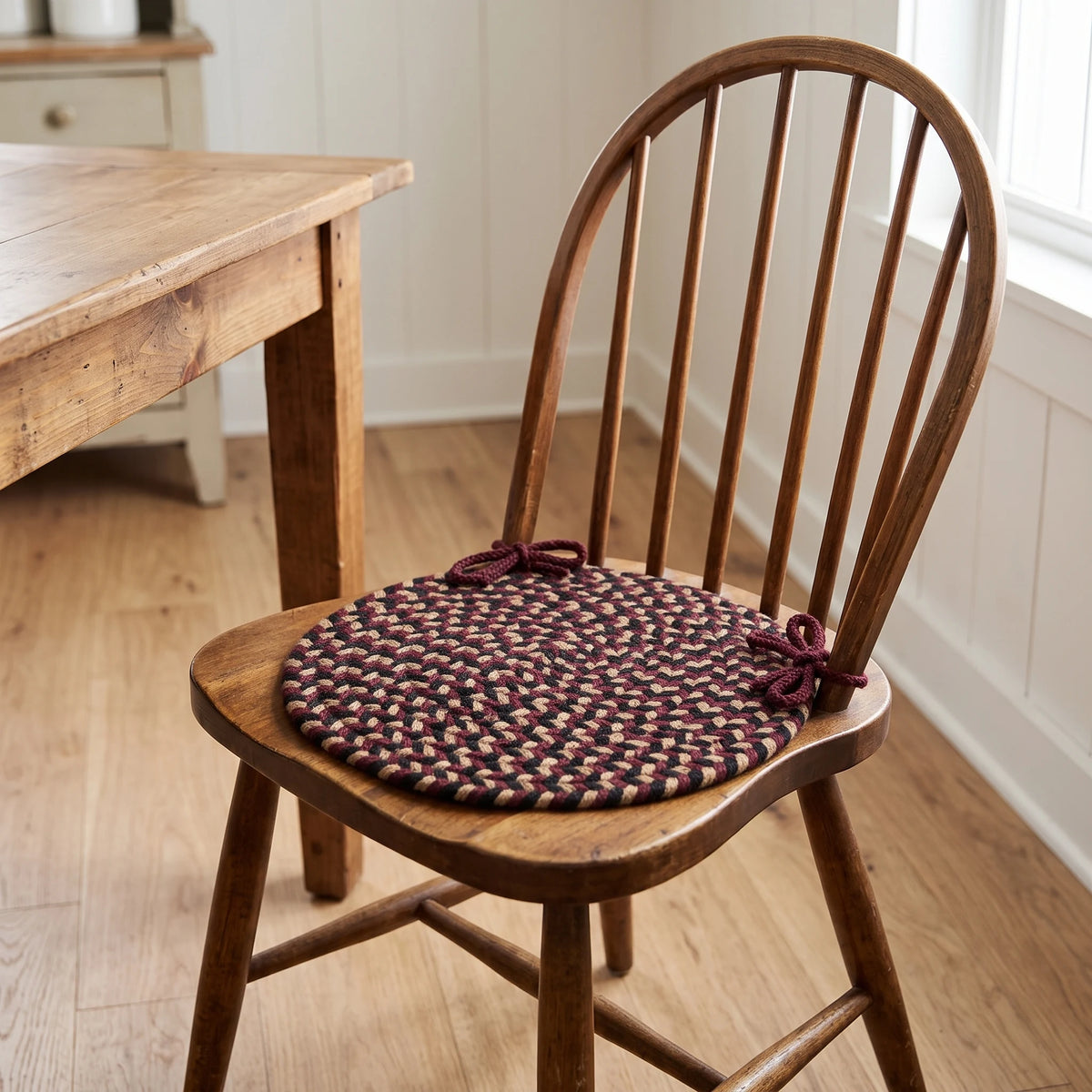 Santa Maria Braided Chair Pad - Sangria - tied on a wooden Windsor dining chair