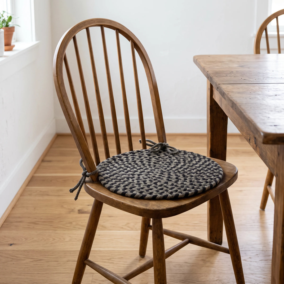 Santa Maria Braided Chair Pad - Forest Green - tied on a wooden Windsor dining chair