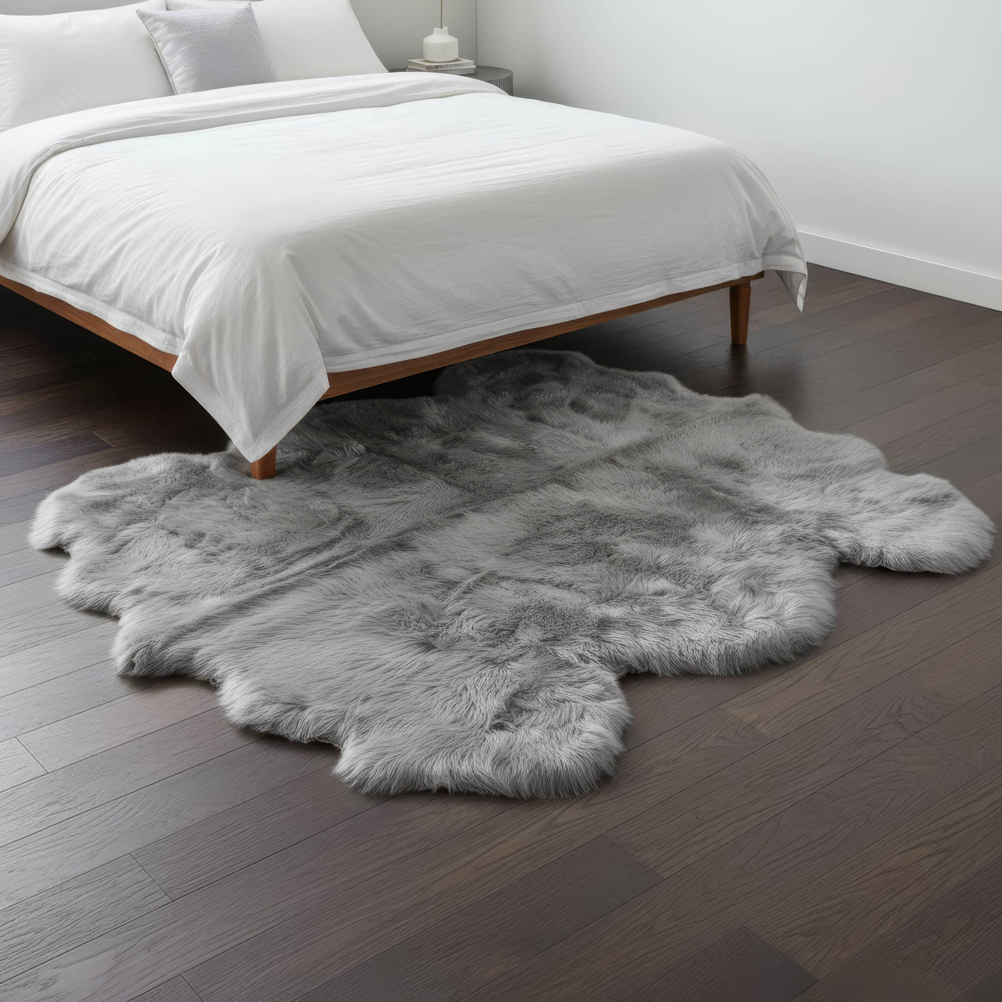 Gray fur rug on a wooden floor in a bedroom setting #size_6' x 6'