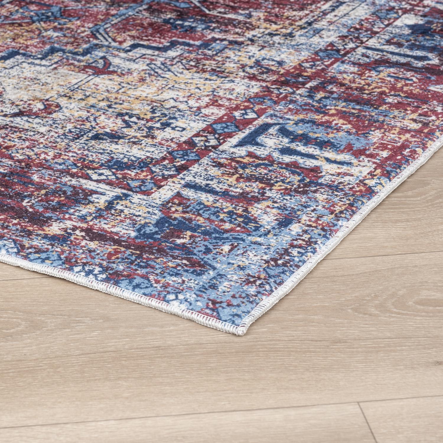 Red Bursa machine washable area rug 4' x 6' - corner detail on hardwood floor