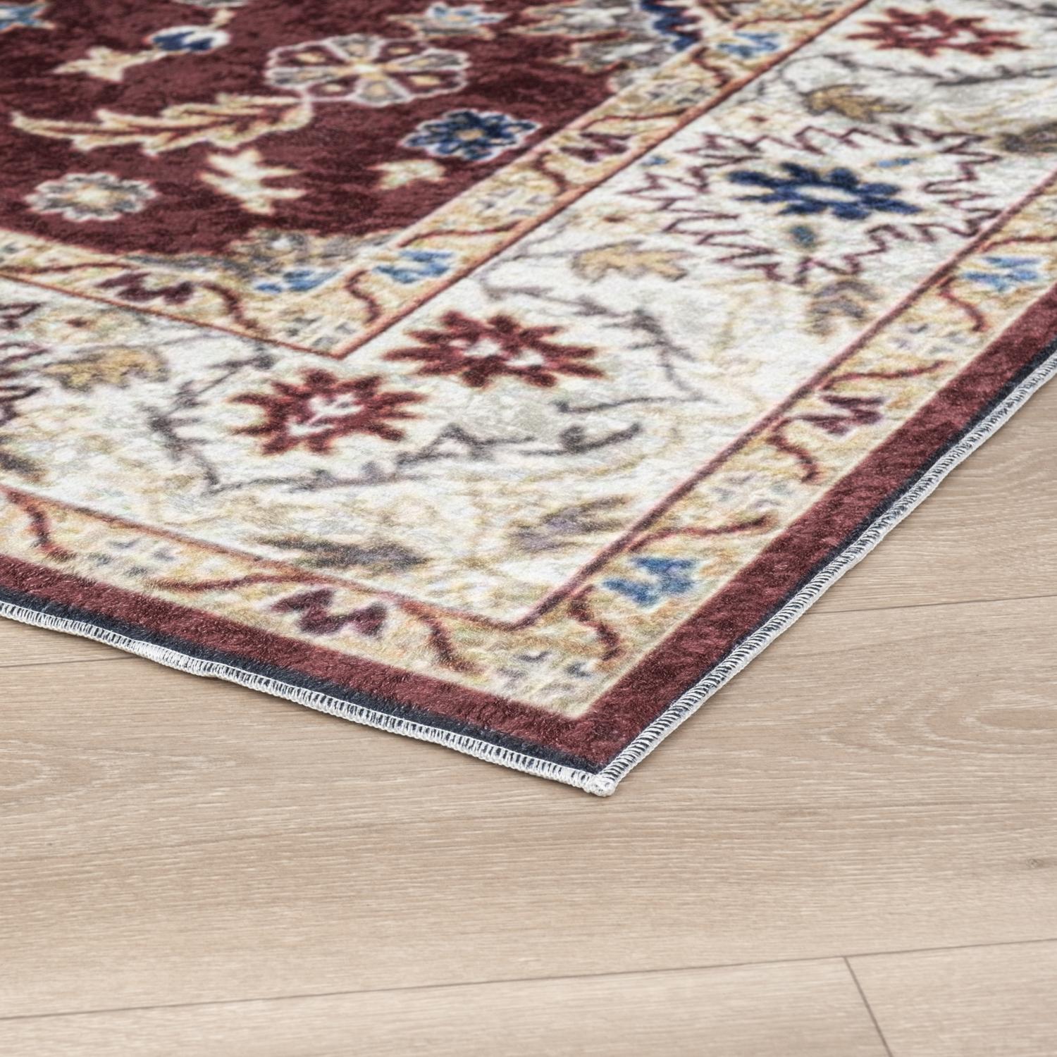 Burgundy Bursa machine washable area rug 5' x 7' - corner detail on hardwood floor