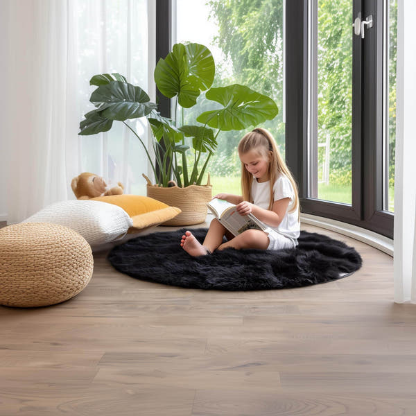 3 ft round black faux fur rug in a sunny playroom with children reading #Size_3' Round