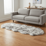 Gray sofa in a living room with a fluffy rug on the floor. #size_2' x 6'