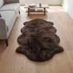 Brown fur rug on a wooden floor in a living room setting#size_2' x 6'
