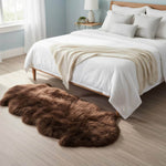 Brown fur rug on a wooden floor in front of a neatly made bed with white  #size_2' x 6'bedding.