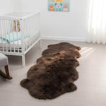 Brown fur rug on a light wooden floor in a nursery with a crib and teddy bear. #size_2' x 6'