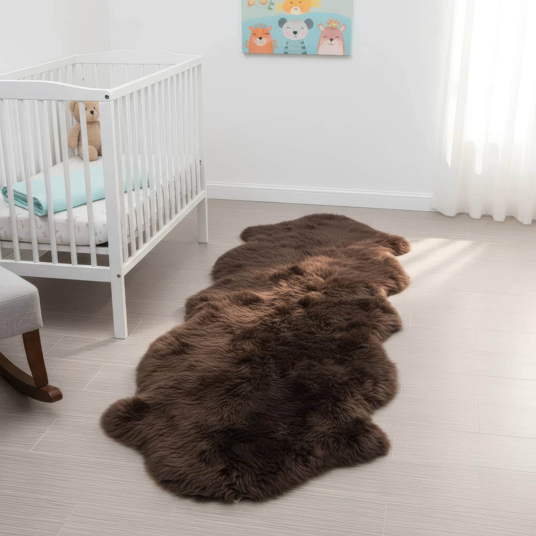 Brown fur rug on a light wooden floor in a nursery with a crib and teddy bear. #size_2' x 6'