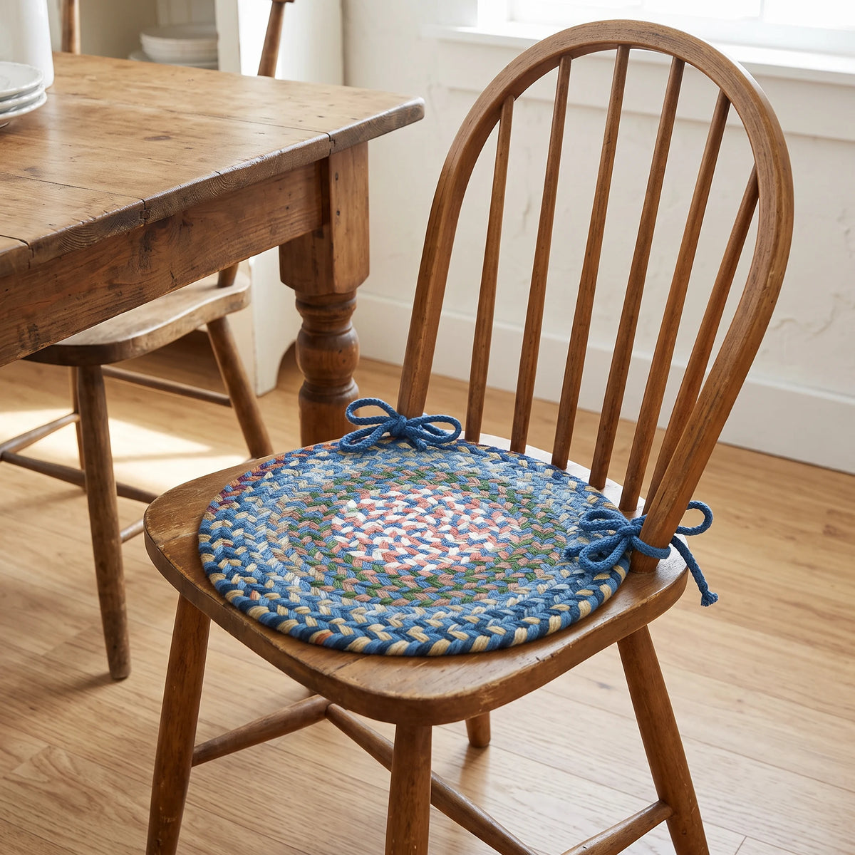 Gemstone Braided Chair Pad - Sapphire - tied on a wooden Windsor dining chair
