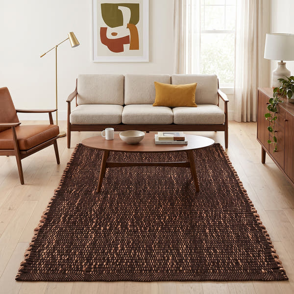 Terra brown jute and cotton rug, 5' x 7', in a living room