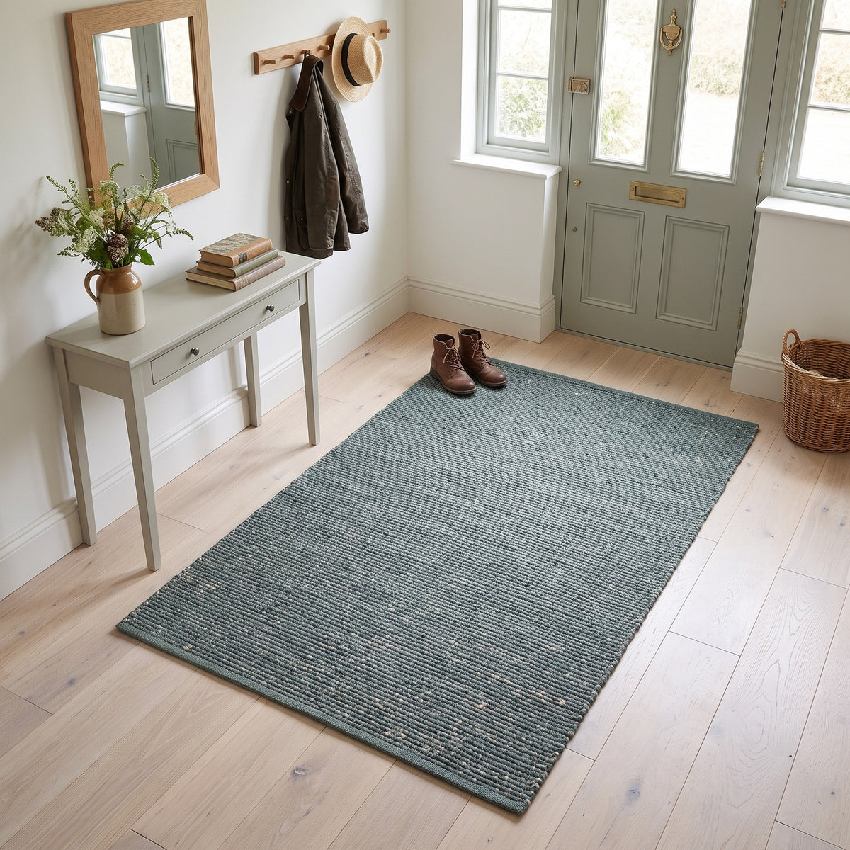 Terra green jute and cotton rug, 3' x 5', in an entryway