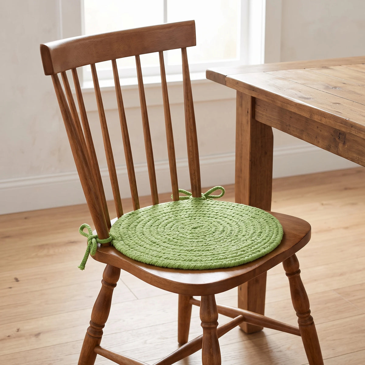 Maui Braided Chair Pad - Key Lime Green - tied on a wooden Windsor dining chair