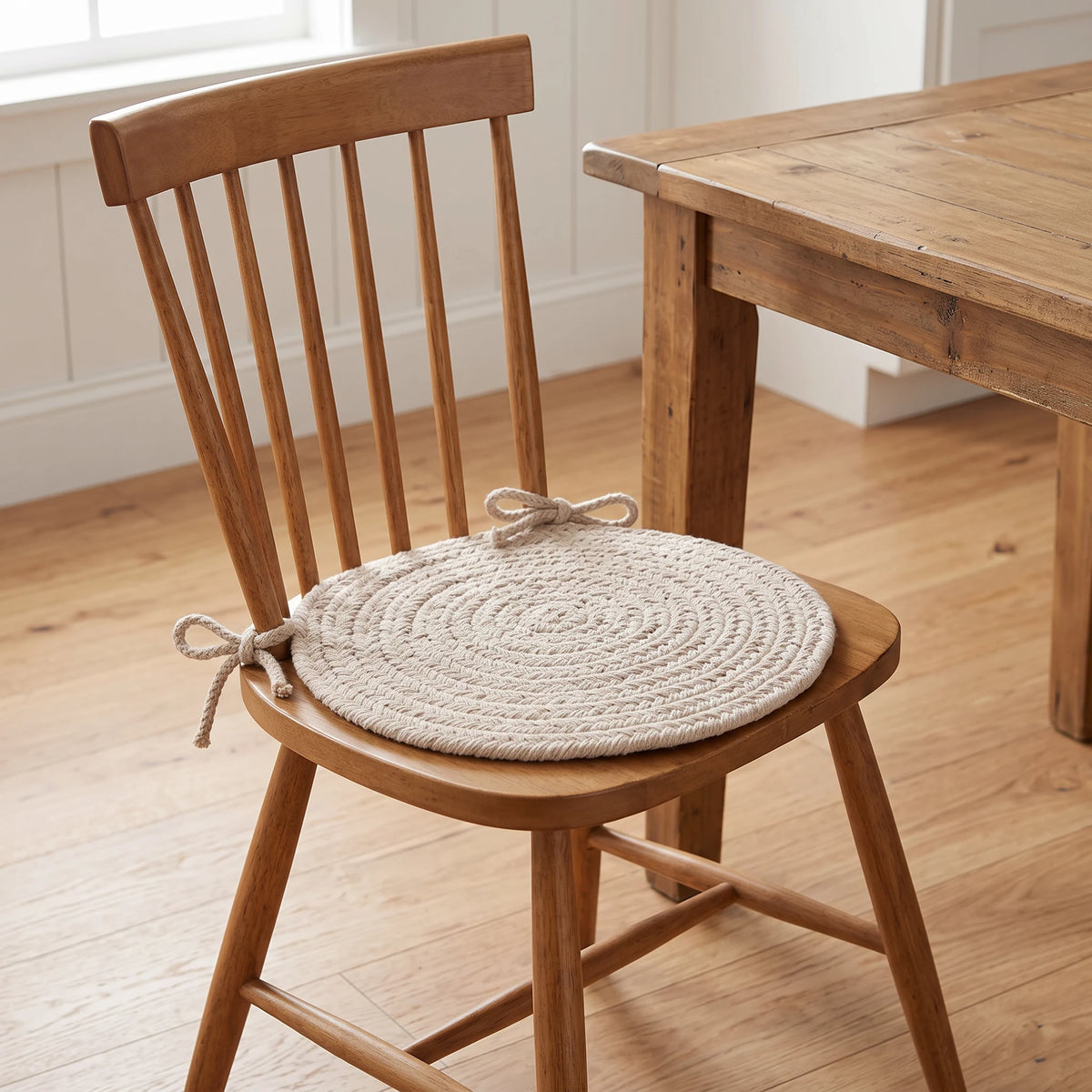 Maui Braided Chair Pad - Pumice Ivory - tied on a wooden Windsor dining chair