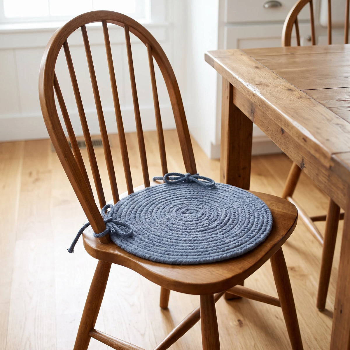 Pura Braided Chair Pad - Sailor Blue - tied on a wooden Windsor dining chair