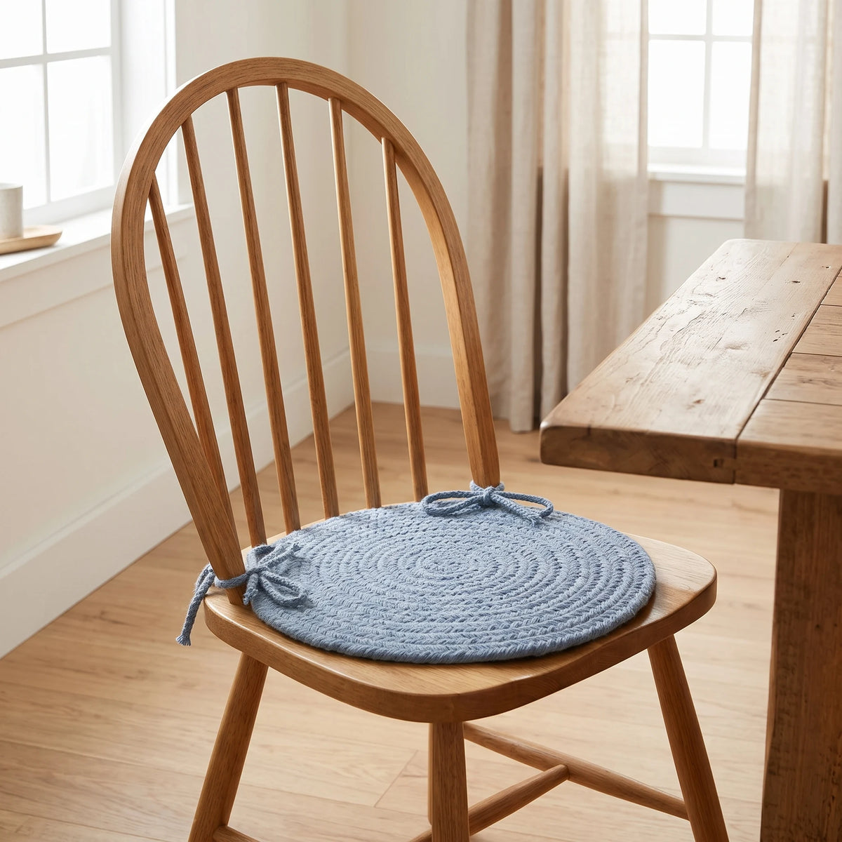 Pura Braided Chair Pad - Bonnet Blue - tied on a wooden Windsor dining chair