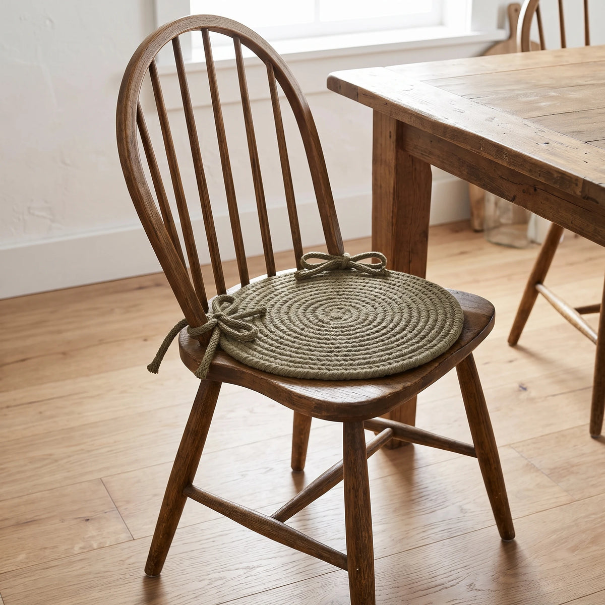 Pura Braided Chair Pad - Moss - tied on a wooden Windsor dining chair