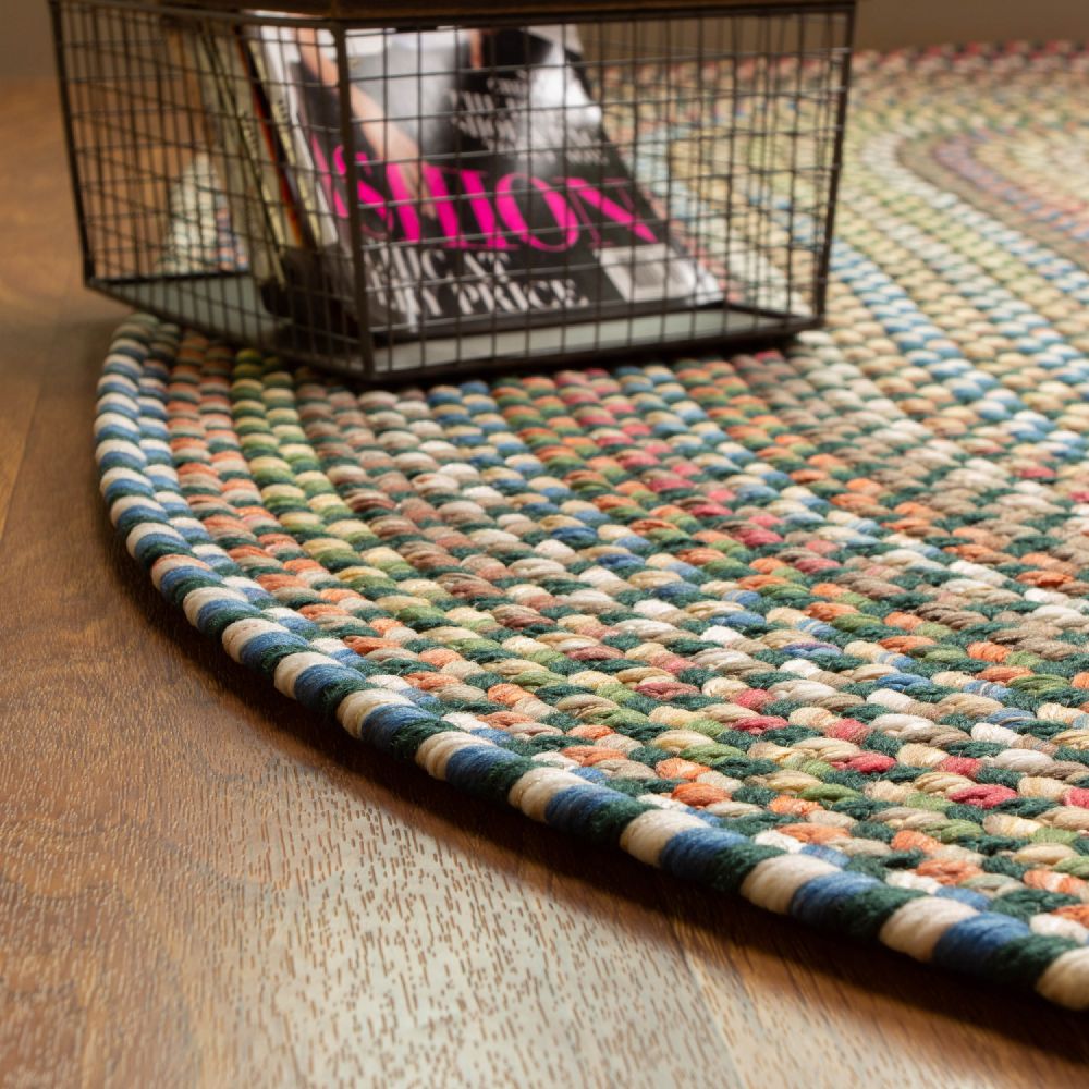 Roxbury Spruce Green braided rug styled in a room setting