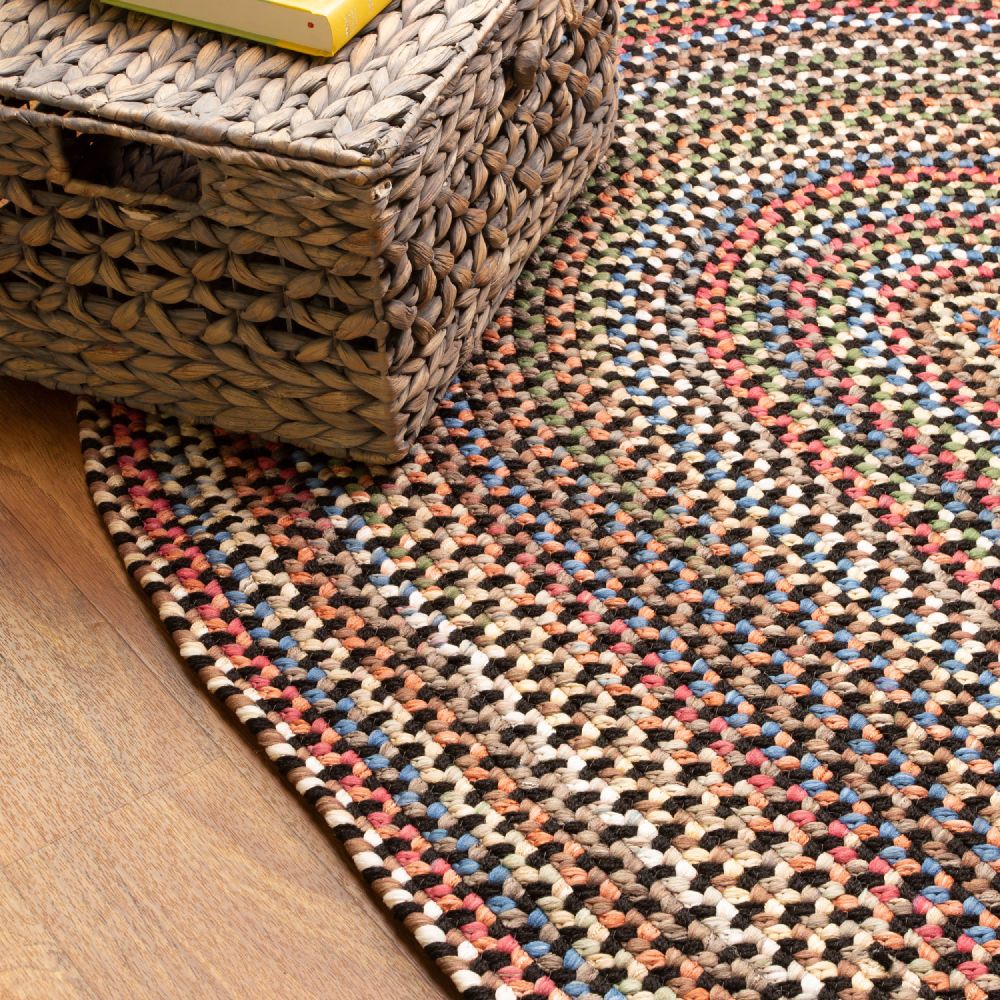 Roxbury Charcoal braided rug styled in a room setting