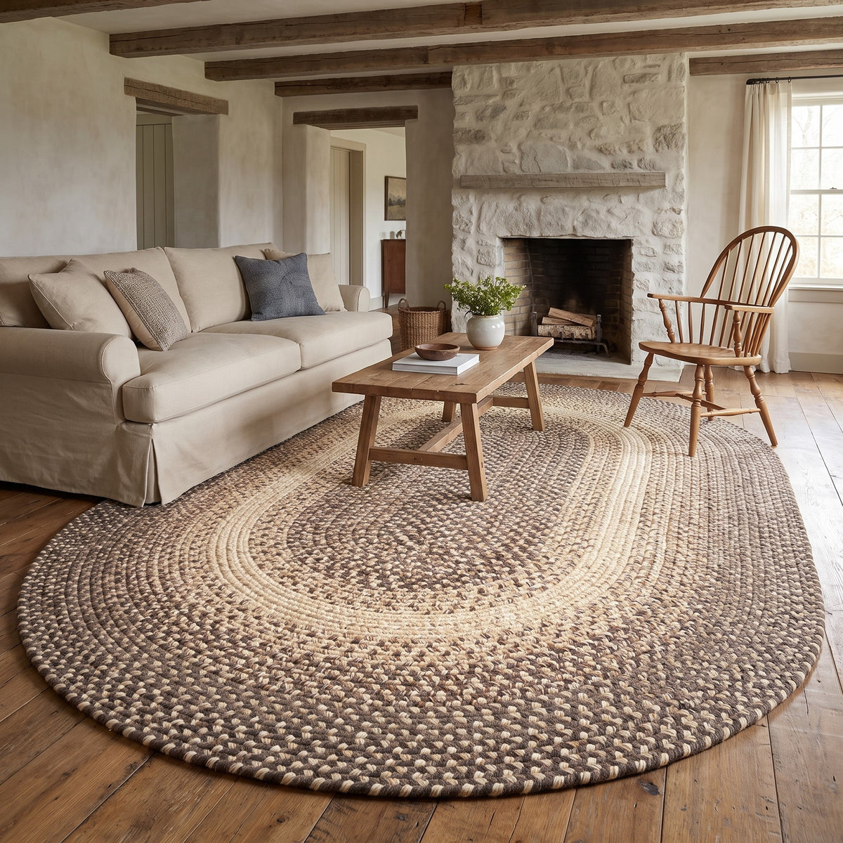 Ridgewood brown braided wool rug, 8x11 oval in an airy rustic living room with stone fireplace #Size_8' x 11' Oval