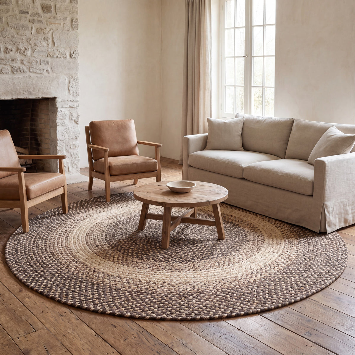 Ridgewood brown braided wool rug, 10 foot round holding a full living room seating group #Size_10' Round