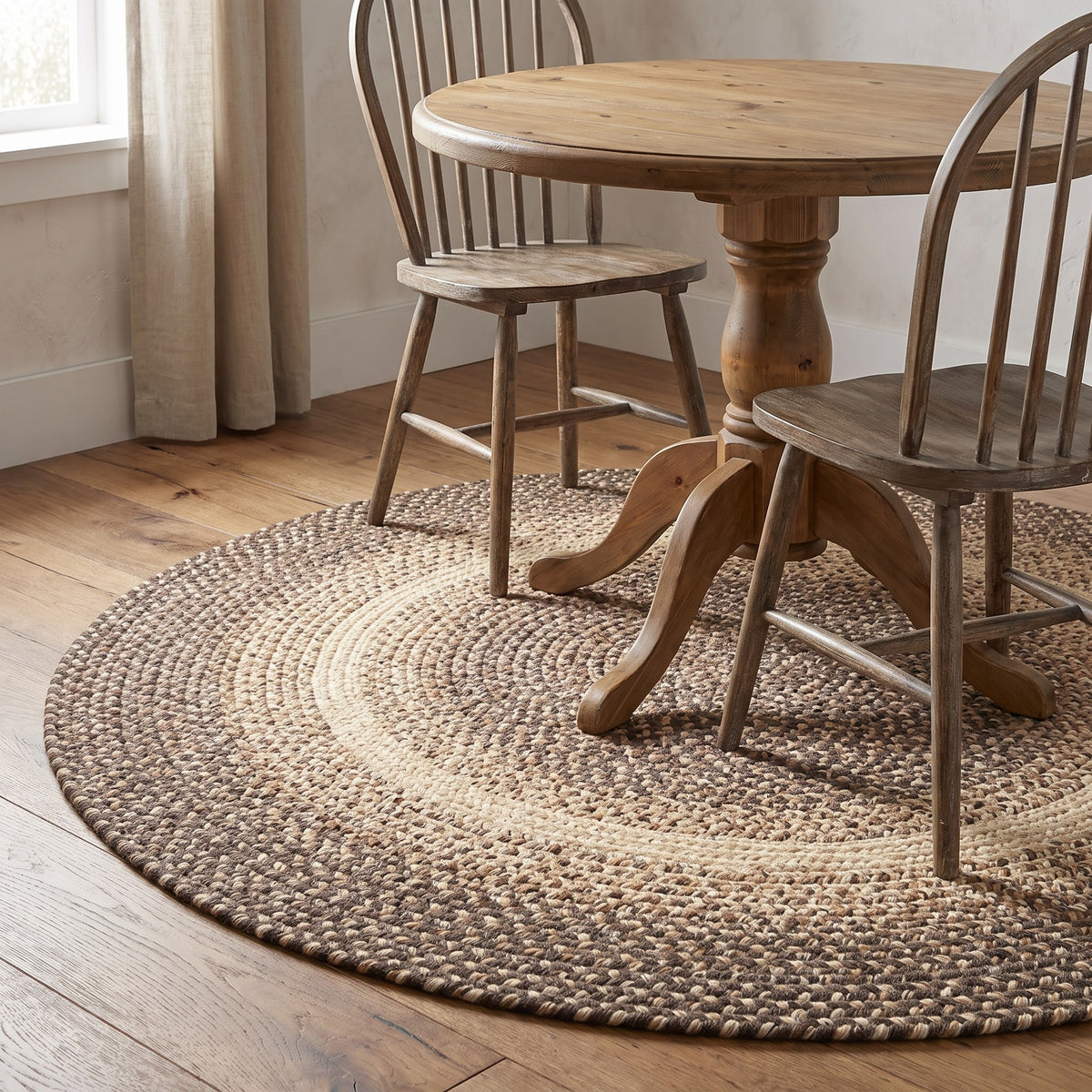 Ridgewood brown braided wool rug, 4 foot round under a bistro table in a farmhouse dining corner #Size_4' Round