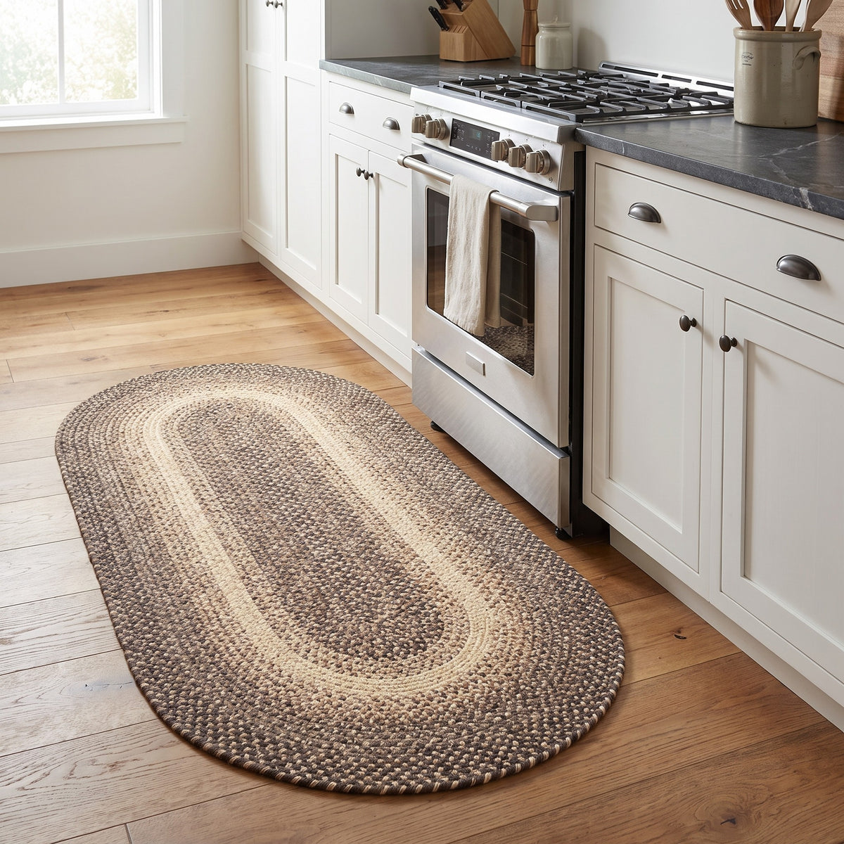 Ridgewood brown braided wool oval runner, 2x4 beside a farmhouse kitchen range #Size_2' x 4' Runner