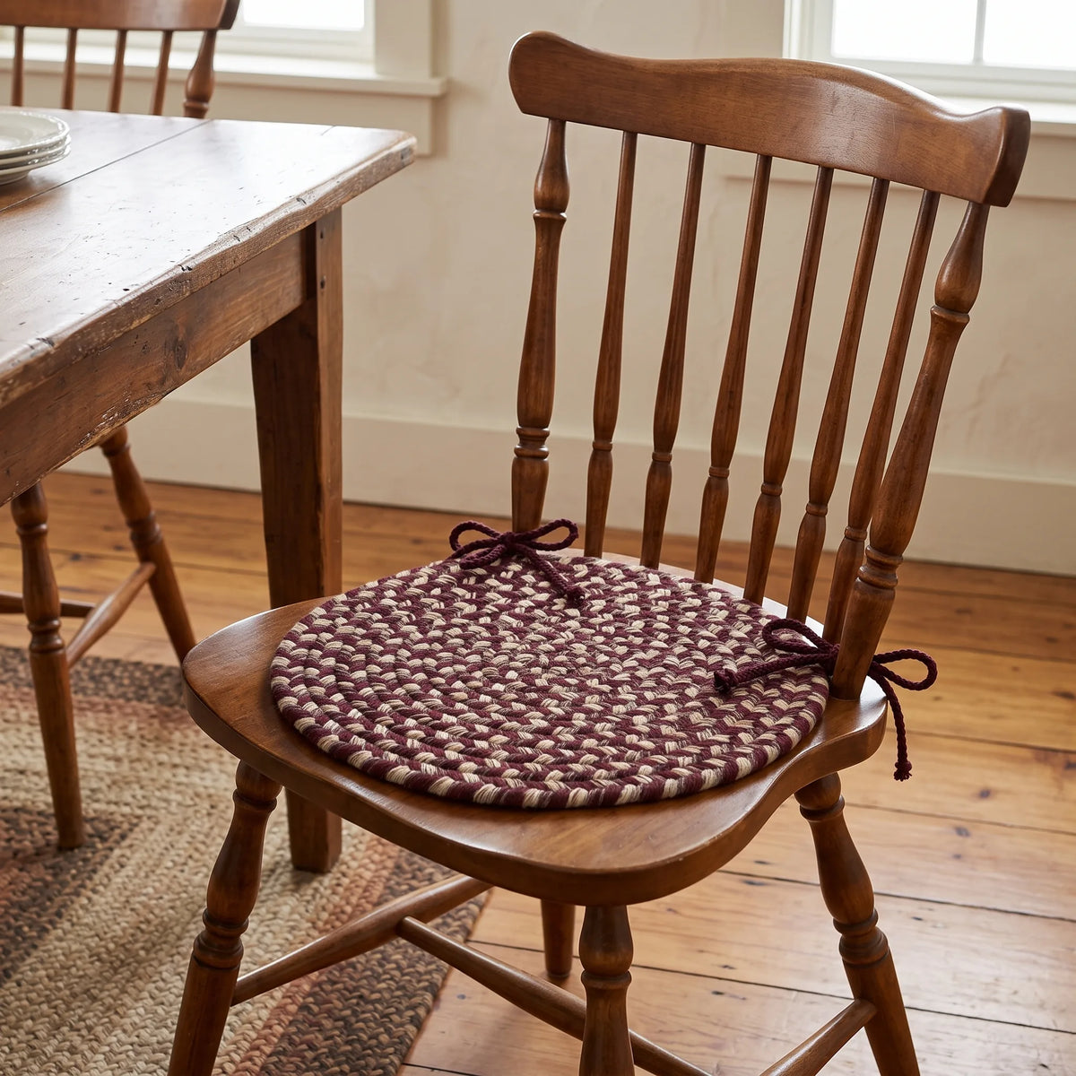 Ridgewood Braided Chair Pad - Burgundy - tied on a classic wooden dining chair