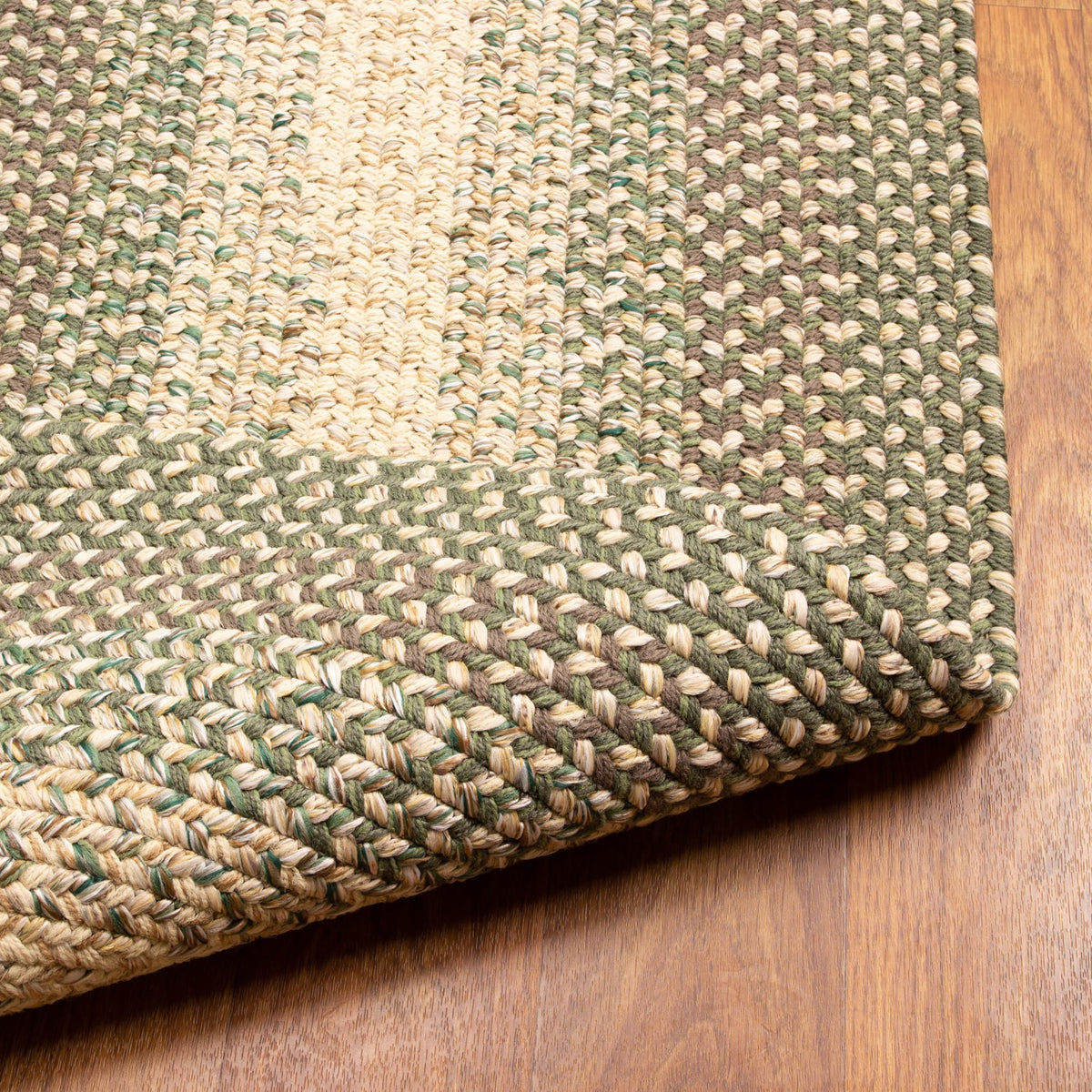 Ridgewood Forest Green braided rug - reversible underside shown folded back