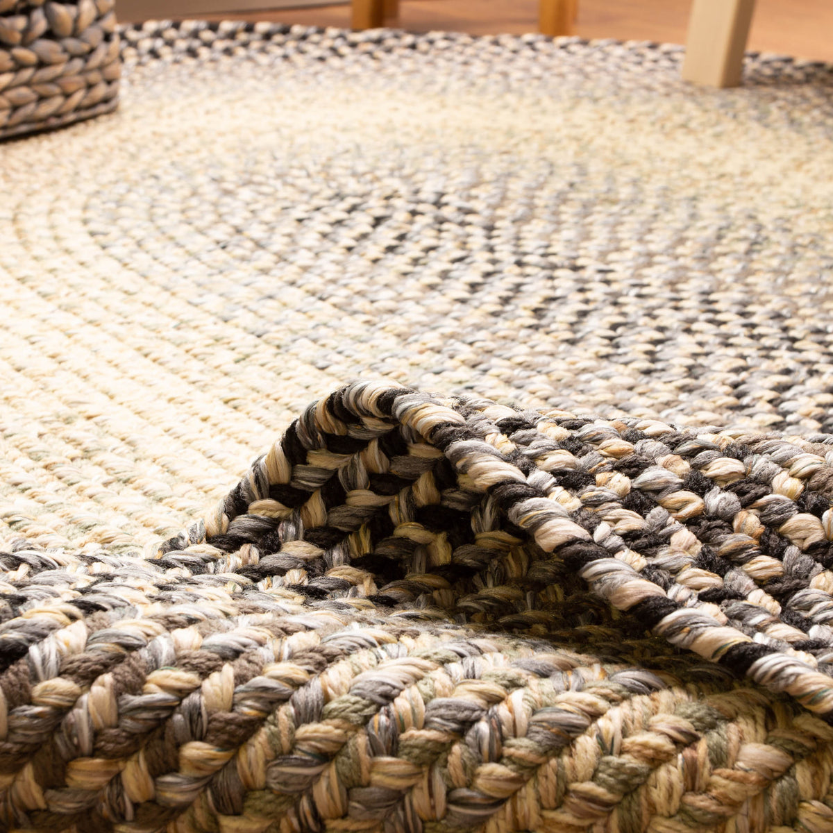 Ridgewood gray braided wool rug - close-up of the braided surface, folded back to show the reversible underside