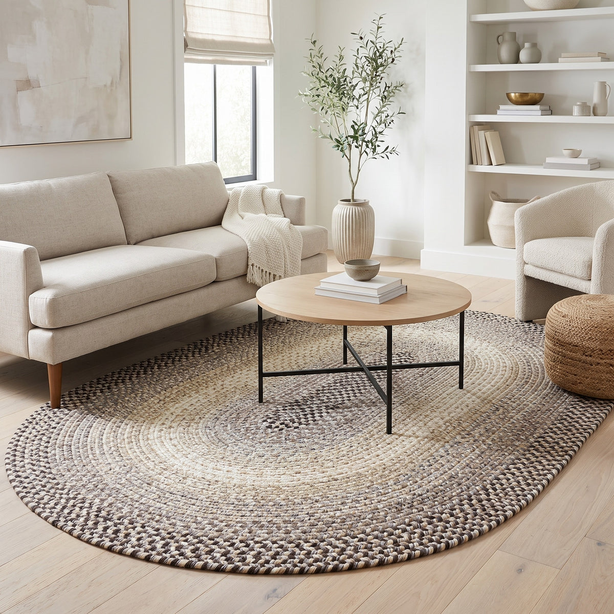 Ridgewood gray braided wool rug, 5x8 oval under the sofa in a modern American living room #Size_5' x 8'