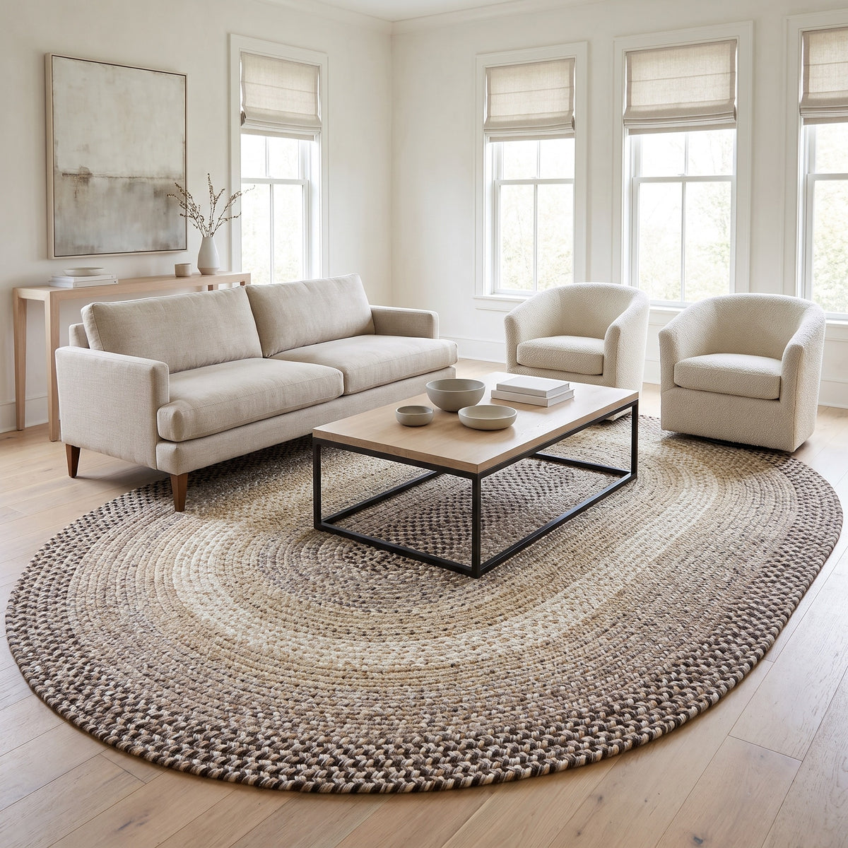 Ridgewood gray braided wool rug, 8x11 oval holding a full seating group in a bright living room #Size_8' x 11' Oval