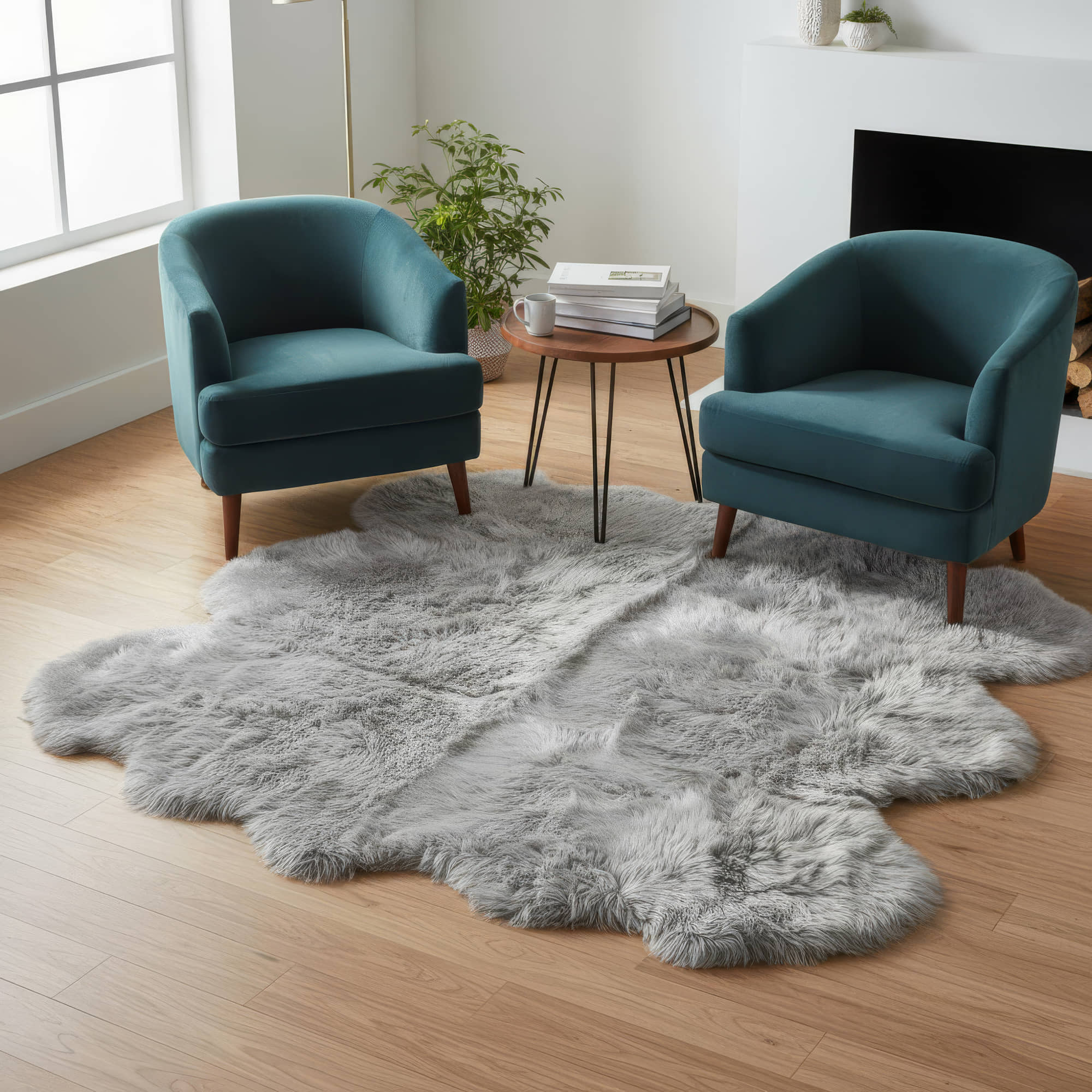 Two teal chairs flanking a gray rug in a room with a small table and plant.  #size_6' x 6'