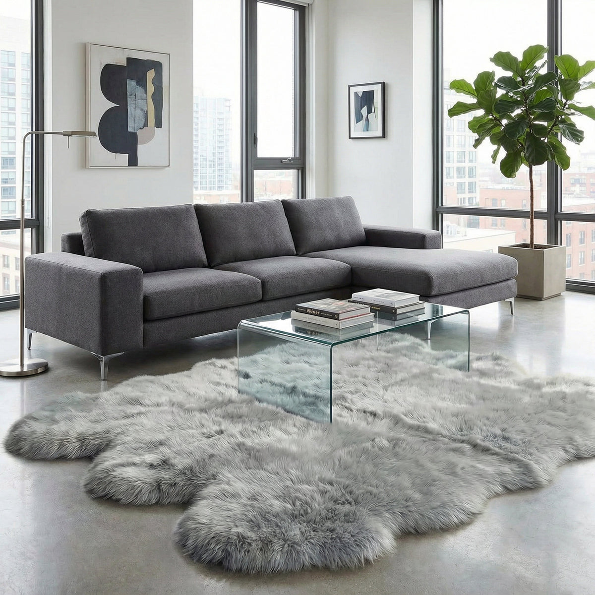 Silver gray sheepskin rug in a modern loft with charcoal sectional and glass coffee table #size_Sexto (6-Pelt) 5×6 ft