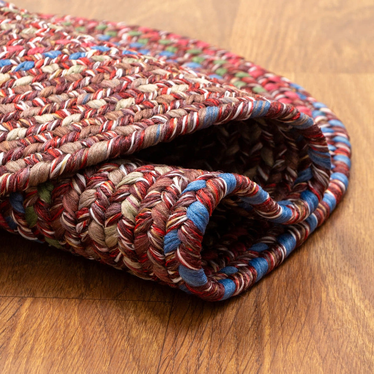 Burgundy & Green Portsmouth rug folded back to show the reversible underside