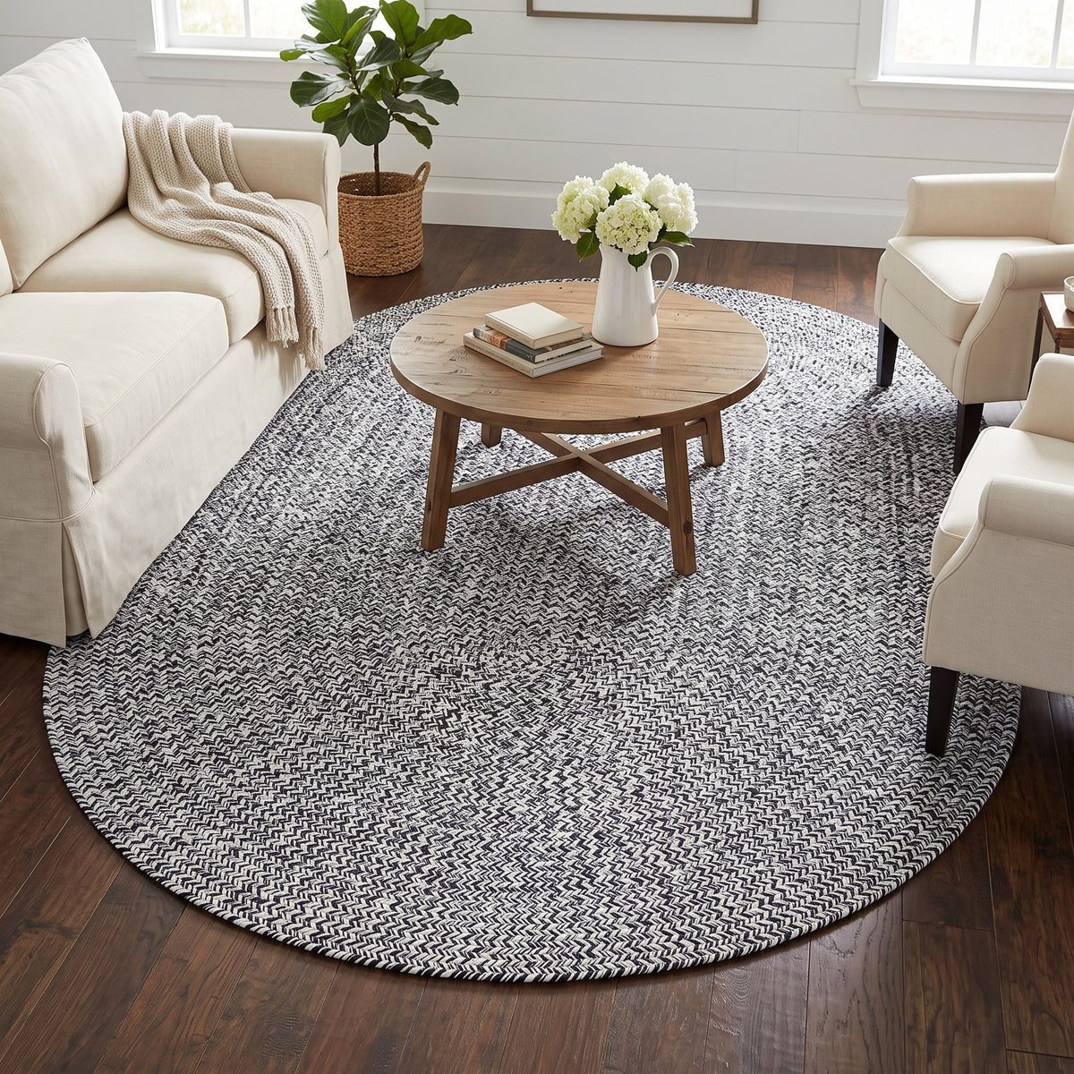 Rustica black and white braided cotton rug, 5x7 oval in a farmhouse living room #size_5' x 7' Oval