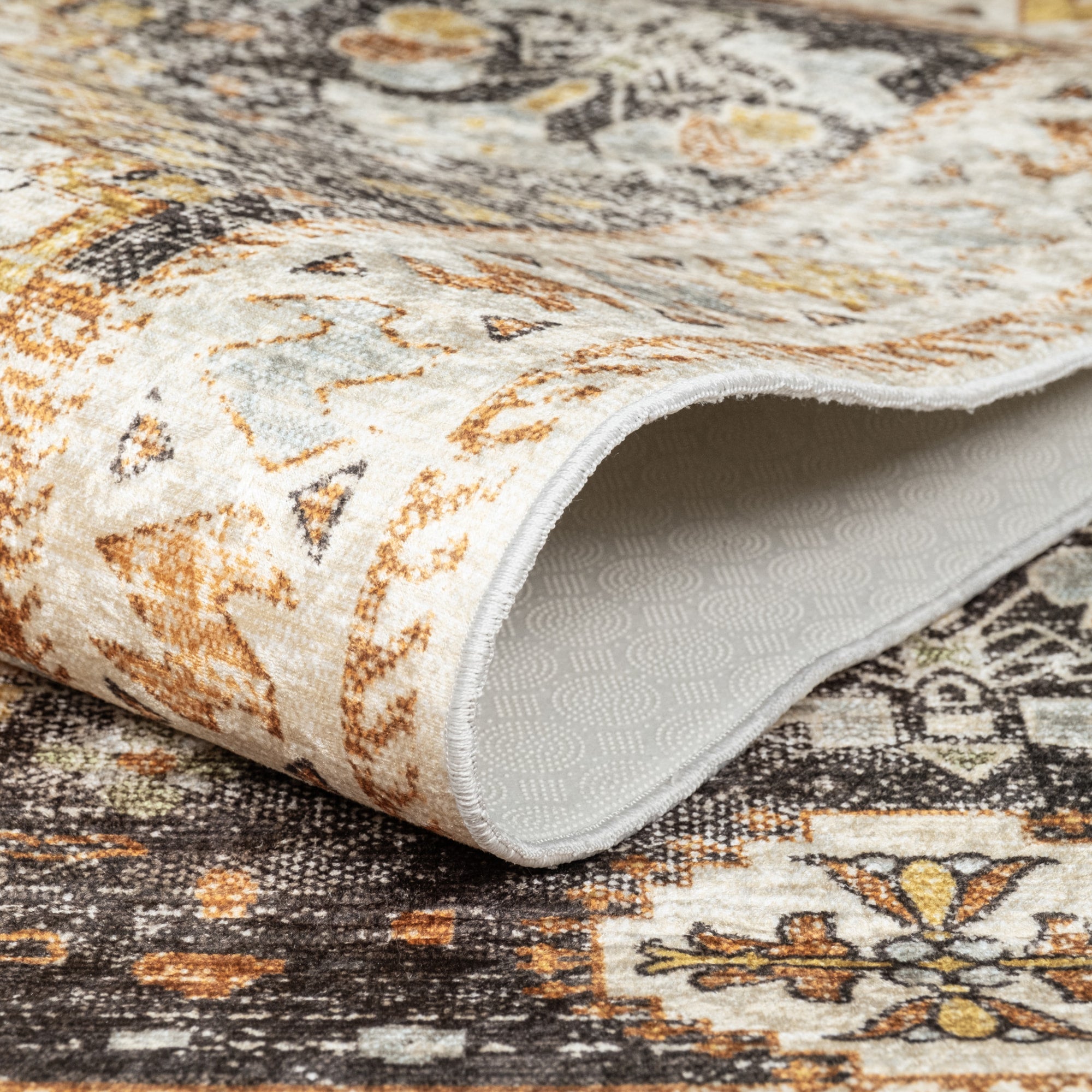 Olive Bursa machine washable area rug 3' x 5' - folded to show the non-slip backing